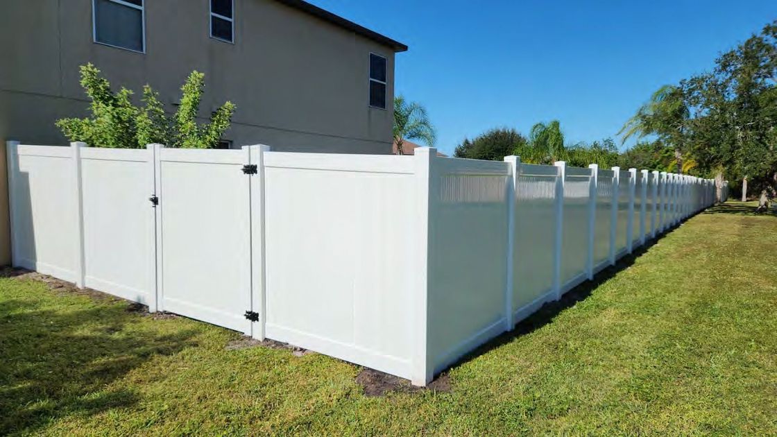 Full privacy vinyl fence enclosing backyard for seclusion