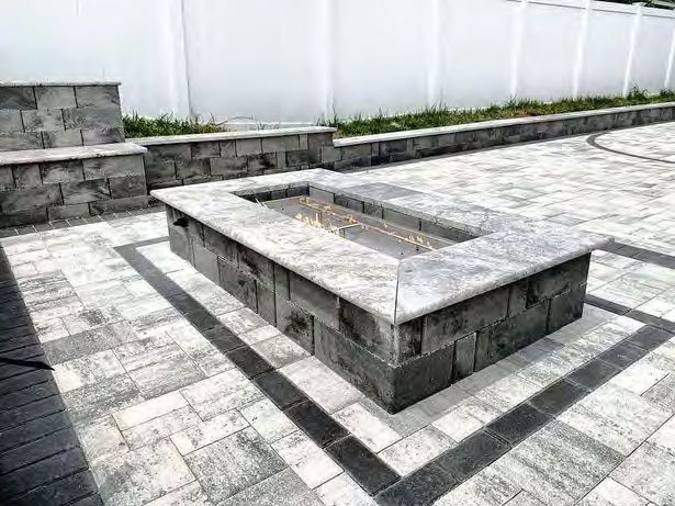 Stone fire pit creating warm gathering spot in Florida backyard