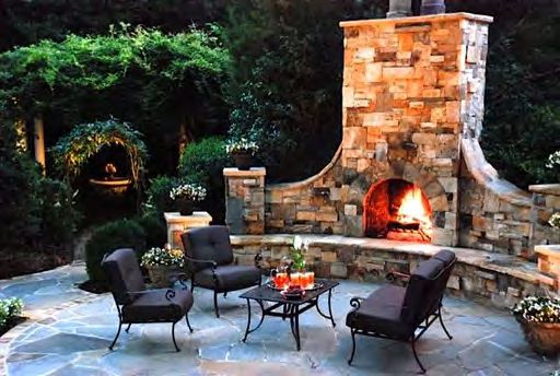 Natural rock outdoor fireplace with built-in seating area