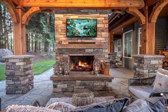 Covered patio outdoor fireplace for year-round warmth and ambiance