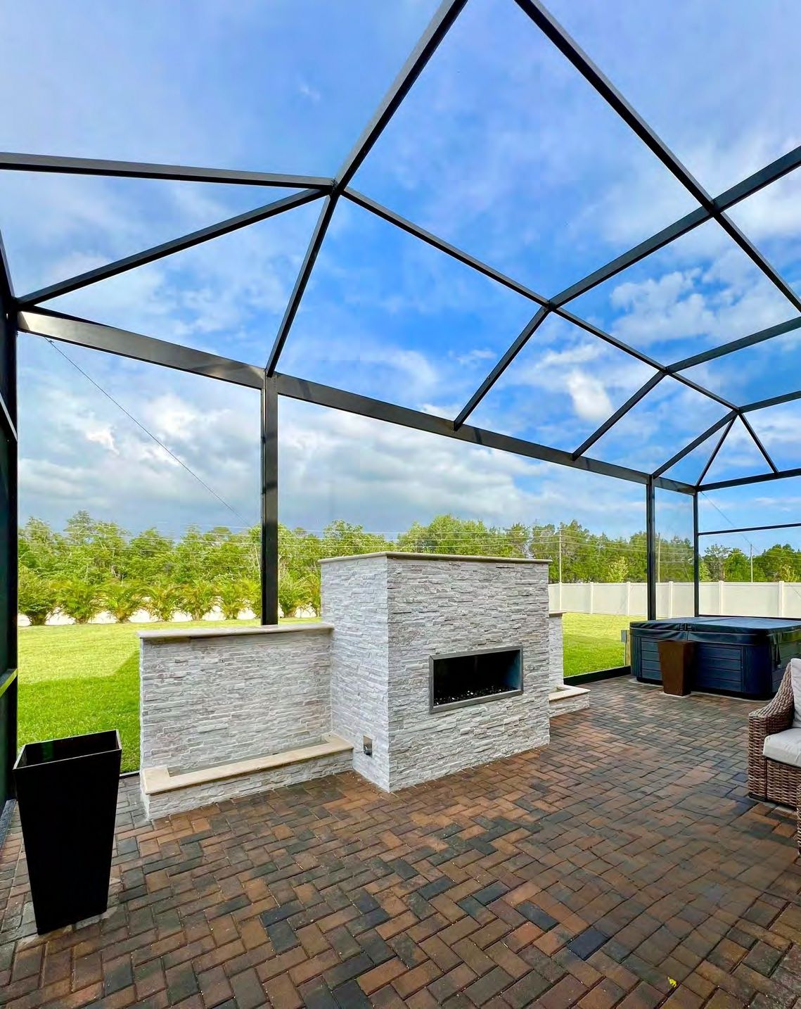 Completed outdoor fireplace project with landscaping integration