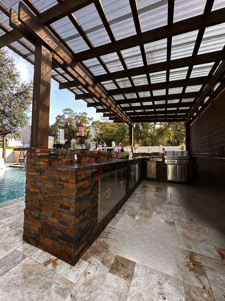 Outdoor kitchen island with built-in grill and bar seating