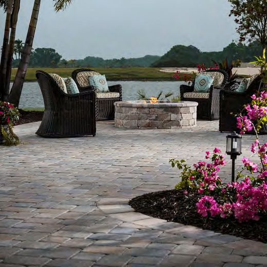 Paver patio installation with herringbone pattern in Florida backyard