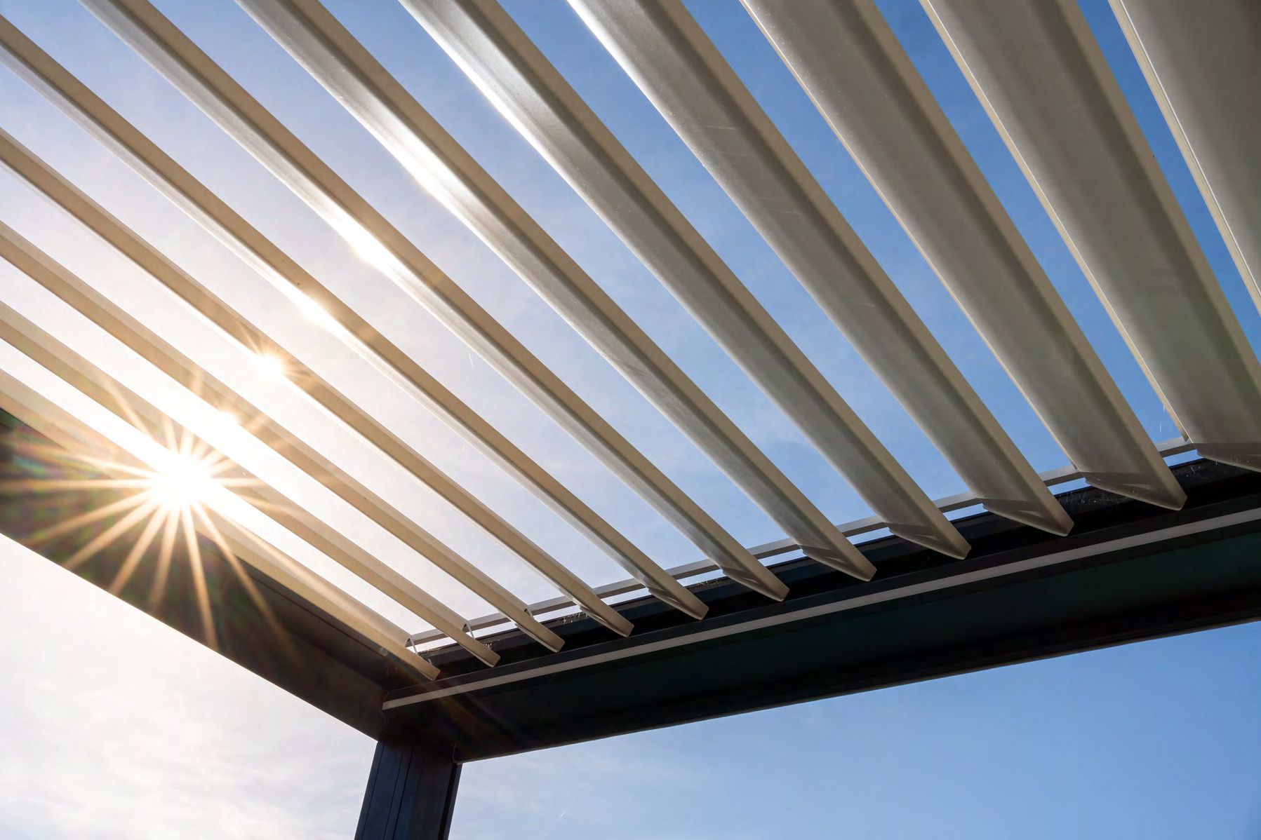 Modern pergola with insulated roofing over outdoor living space