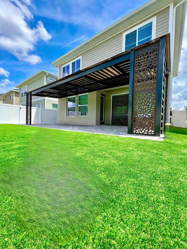 Decorative cut-out privacy wall panel on outdoor pergola