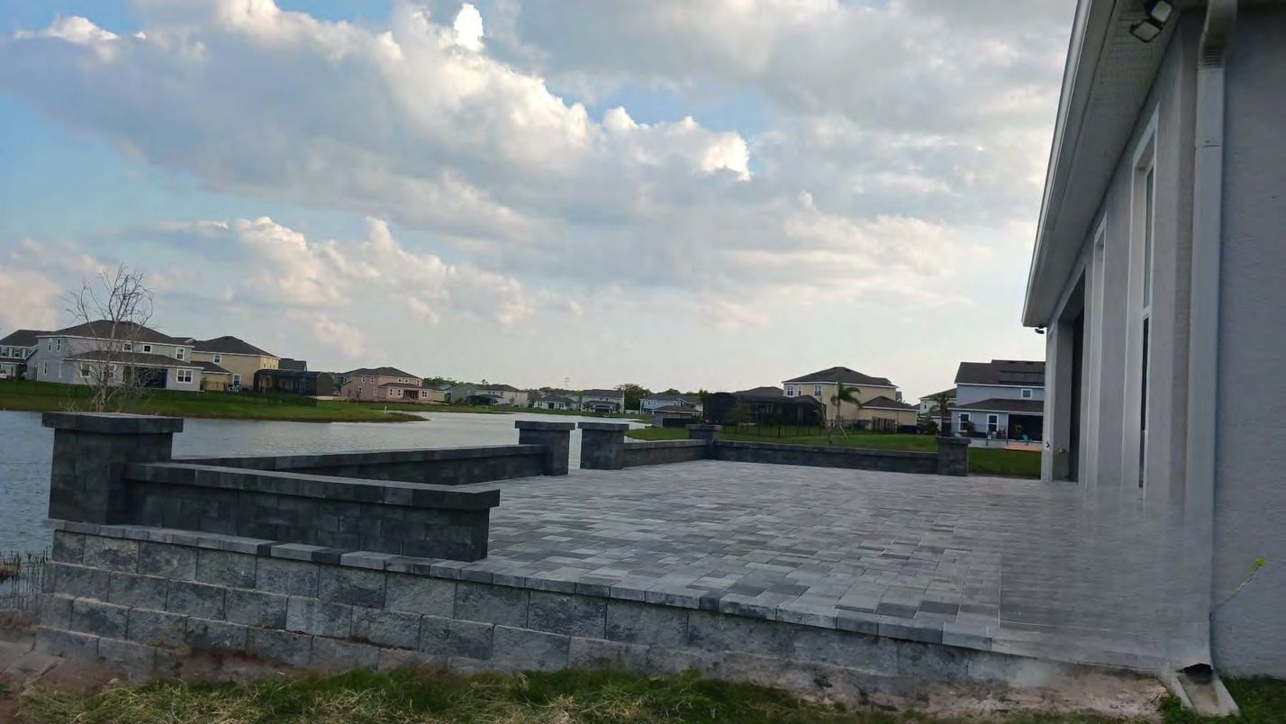 Stone retaining wall preventing erosion on sloped Florida yard