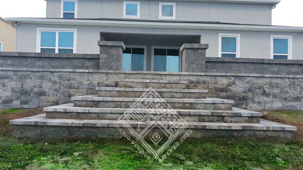 Concrete block retaining wall creating leveled garden terrace