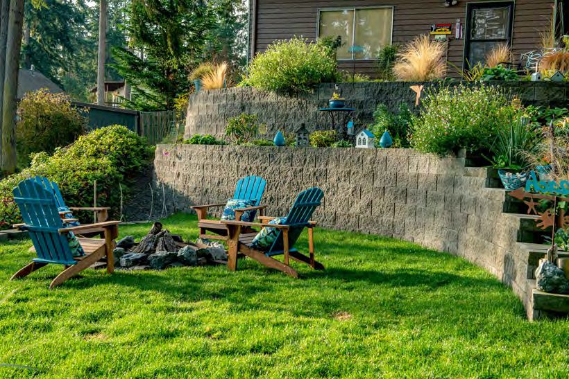 Decorative retaining wall boosting curb appeal with stone finish