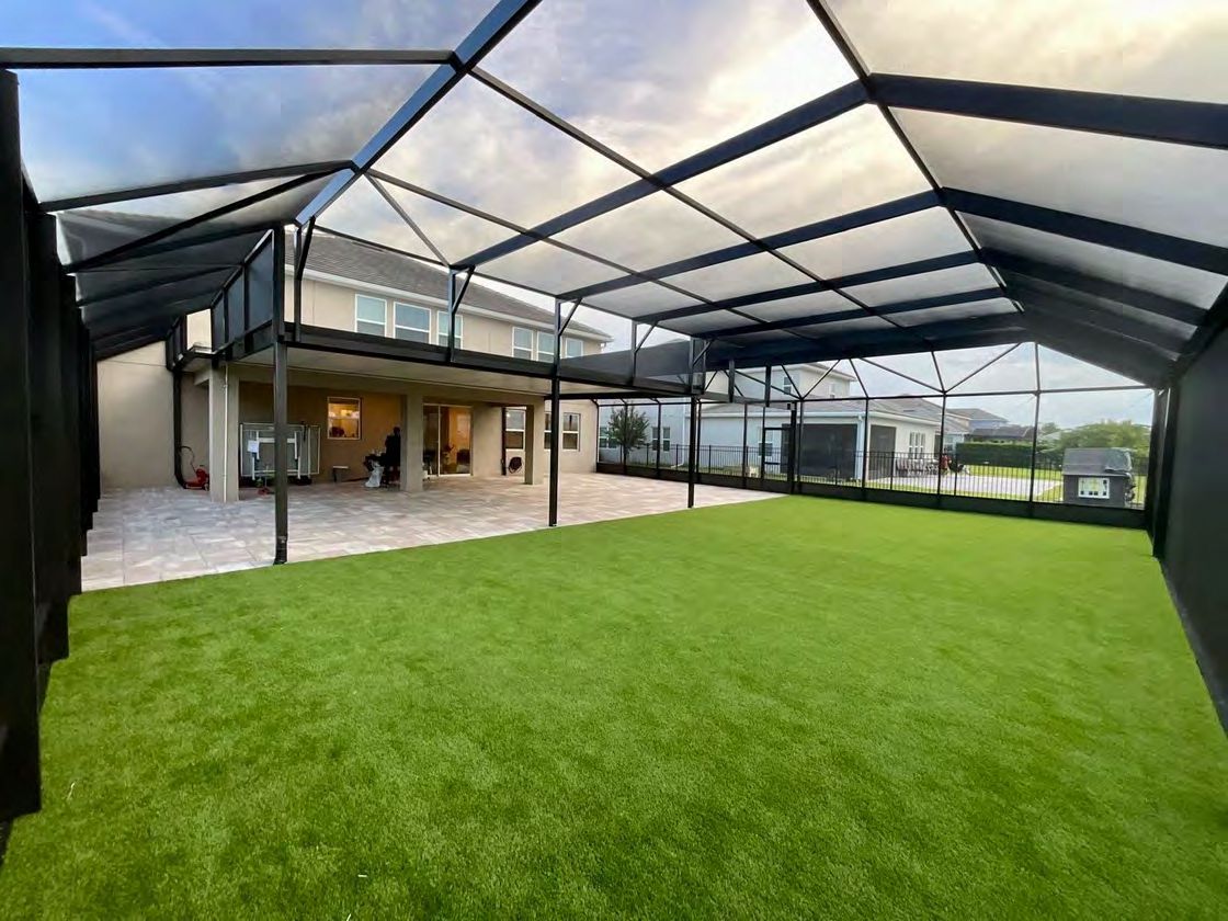Sloped roof screen enclosure for residential backyard