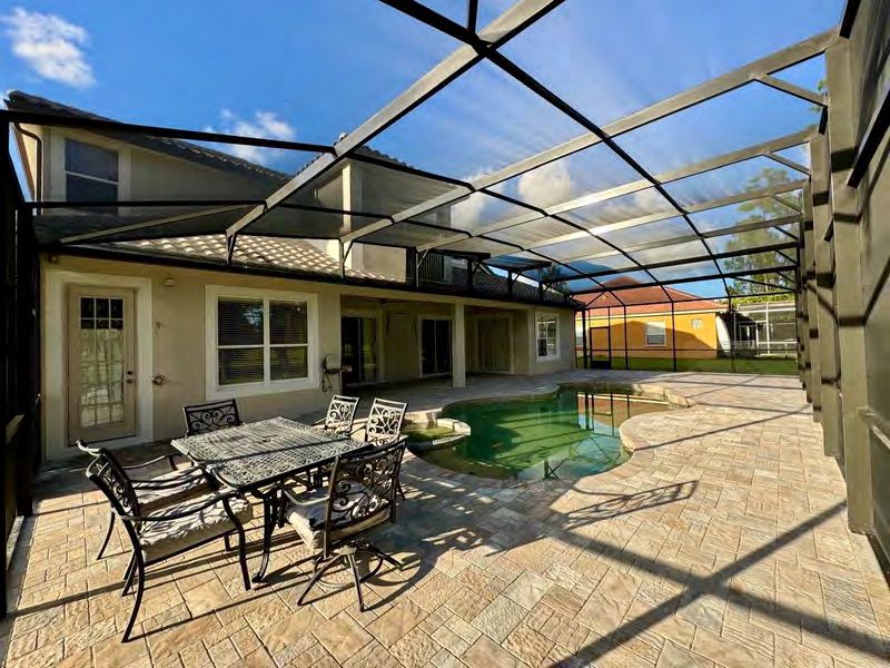 Pool screen enclosure protecting swimming area from insects and debris