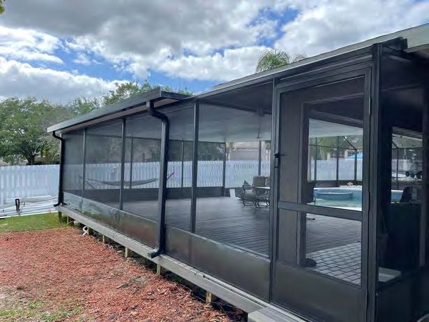 Large patio screen enclosure covering outdoor living area
