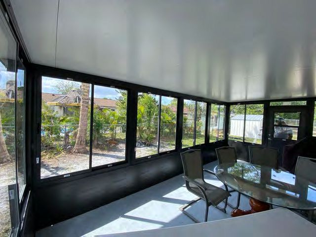 Enclosed sunroom with insulated dual-pane Low-E glass walls
