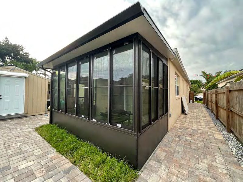 Climate-controlled sunroom addition with panoramic glass views